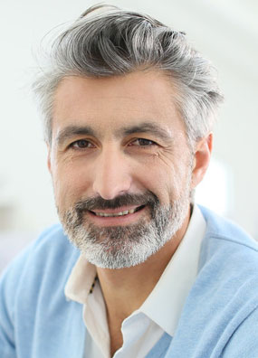 older male with grey hair smiling